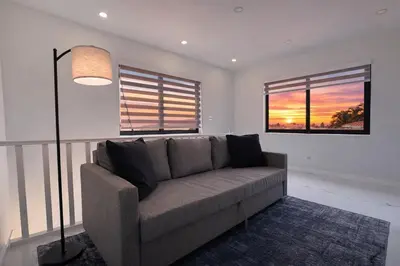 a living room with a couch and two windows at Luxury 1 King BR Retreat near Calle Ocho in Miami