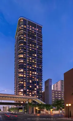 a tall building with lights on in a city at Elegant Condo Near Bayside in Central Miami in Miami