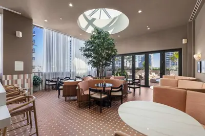 a restaurant with tables and chairs and large windows at Central Downtown Miami Condo Featuring Rooftop Pool in Miami