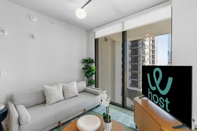 a living room with a couch and a large window at Central Downtown Miami Condo Featuring Rooftop Pool in Miami