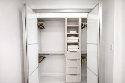 a walk in closet with white walls and a mirror at Luxury 2BR Miami Retreat King Suite Free Parking in Miami