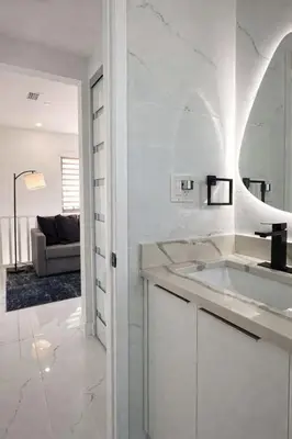 a white bathroom with a sink and a mirror at Luxury 2BR Miami Retreat King Suite Free Parking in Miami