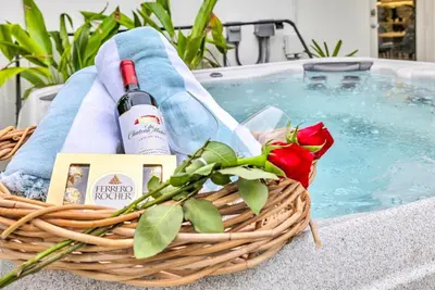 a basket with a bottle of wine and a red rose at Tropical Bliss 15 Min to Beach in Plantation