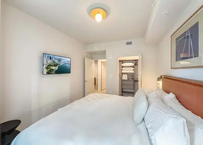 a bedroom with a large white bed and a tv at MIA Worldcenter Premium 1BR Balcony & Rooftop Pool in Miami