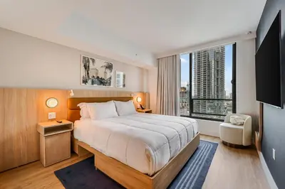 a bedroom with a large bed and a large window at Chic studio in Downtown with Gym and Pool in Miami