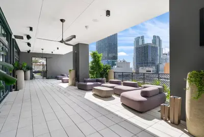 a room with purple couches and a view of a city at Chic studio in Downtown with Gym and Pool in Miami