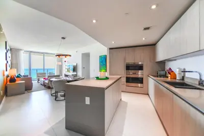 a kitchen and living room with a view of the ocean at Ocean Views Plus Beachside & Roofpool in Hollywood