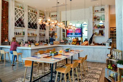 a restaurant with tables and chairs and a bar at Ocean Views Plus Beachside & Roofpool in Hollywood