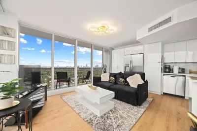 a living room with a couch and a large window at Elegant Condo with Stunning Views in Dtwn Hollywood in Hollywood