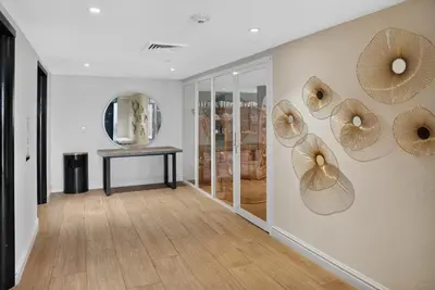 a hallway with wooden floors and mirrors on the wall at Mondrian in Miami Beach