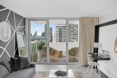 a living room with a view of a city at Mondrian in Miami Beach