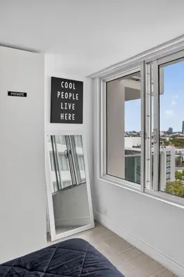 a sign that reads god people live here next to a window at Mondrian in Miami Beach