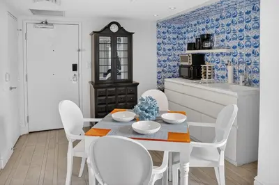 a dining room with a white table and white chairs at Mondrian in Miami Beach