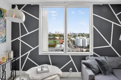 a living room with a window and a couch at Mondrian in Miami Beach