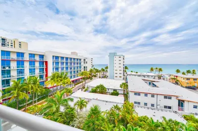 a view of the beach from the balcony of a resort at Ocean View Stay with Rooftop Pool Near the Beach in Hollywood
