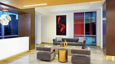 a living room with a couch and a table at Ocean View Stay with Rooftop Pool Near the Beach in Hollywood