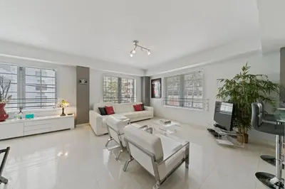 a white living room with a couch and chairs at South Beach, Perfect Oceanfront Apartment, Iconic Art Deco Building, Walk to Everything! in Miami Beach