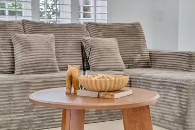a living room with a couch and a table at Spacious & Stylish 2BR Retreat near Victoria Park in Fort Lauderdale