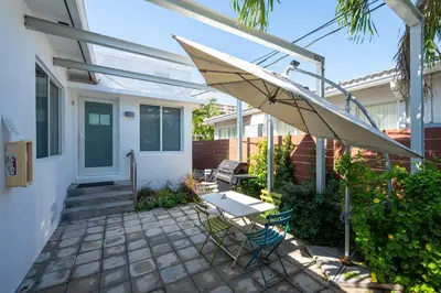 a patio with a table and an umbrella at Vista Del Mar - by Atlantikos in Hollywood