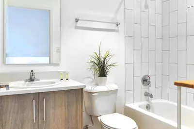 a bathroom with a toilet and a sink and a tub at Spacious Entire Duplex for Family Stay in Miami