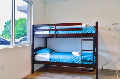 two bunk beds in a room with a window at Spacious Entire Duplex for Family Stay in Miami