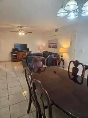a living room with a table and a couch at Le Cartier 207 STR-02440 in Sunny Isles Beach