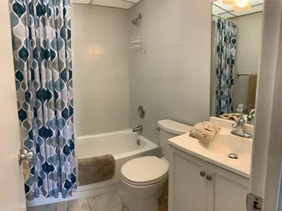 a bathroom with a toilet and a tub and a sink at Le Cartier 207 STR-02440 in Sunny Isles Beach