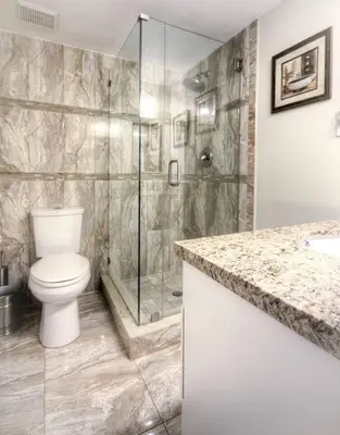 a bathroom with a toilet and a glass shower at Le Frontenac 205 STR-01057 in Sunny Isles Beach