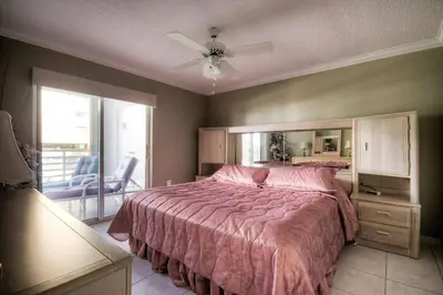 a bedroom with a large bed and a ceiling fan at Le Frontenac 205 STR-01057 in Sunny Isles Beach