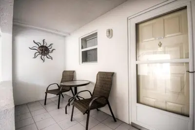 a room with a table and chairs and a spider on the wall at Le Frontenac 205 STR-01057 in Sunny Isles Beach