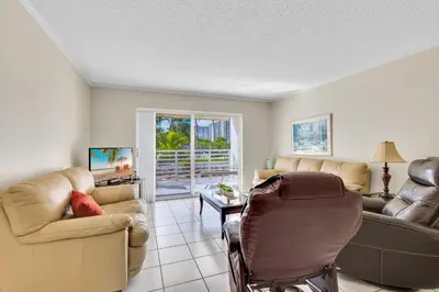 a living room with a couch and a chair at Le Frontenac 210 STR-01055 in Sunny Isles Beach