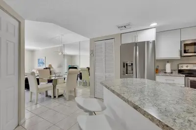 a kitchen and dining room with a table and chairs at Le Frontenac 210 STR-01055 in Sunny Isles Beach