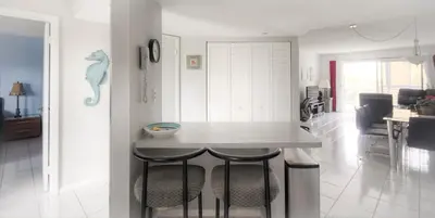 a kitchen with a table and chairs in a room at Le Frontenac 404 STR-02799 in Sunny Isles Beach