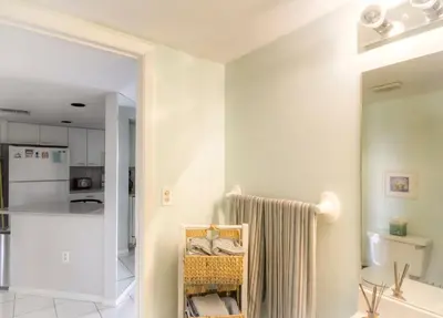 a white bathroom with a sink and a kitchen at Le Frontenac 404 STR-02799 in Sunny Isles Beach