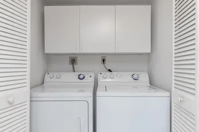 a white kitchen with white cabinets and white appliances at Le Frontenac 414 STR-01532 in Sunny Isles Beach