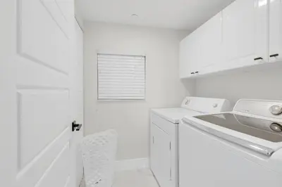 a white laundry room with a sink and a washing machine at Le Golden Bay 902 STR-00876 in Sunny Isles Beach