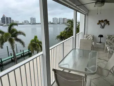 a balcony with a table and a view of the water at Le Laurier in Sunny Isles Beach