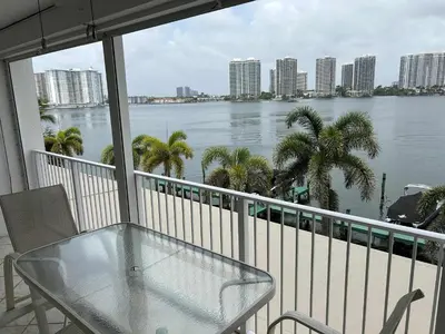 a balcony with a table and a view of the water at Le Laurier in Sunny Isles Beach