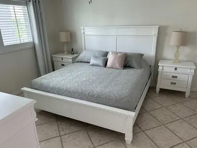 a white bed with two pillows on it in a bedroom at Le Laurier in Sunny Isles Beach