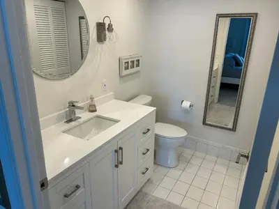 a bathroom with a sink and a toilet and a mirror at Le Laurier in Sunny Isles Beach