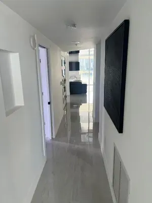 a hallway with white walls and a long hallway with at Le Marina Bay 1001 STR-01504 in Sunny Isles Beach