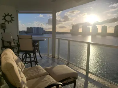 a balcony with a couch and a view of the water at Le Marina Bay 1001 STR-01504 in Sunny Isles Beach