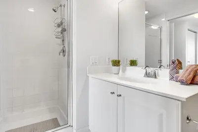 a white bathroom with a sink and a shower at Le Marina Bay 1004 STR-02738 in Sunny Isles Beach