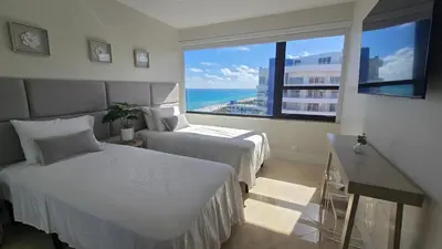 a bedroom with two beds and a large window at Penthouse Condo - Oceanfront - Miami Beach - sleeps 8 in Miami Beach