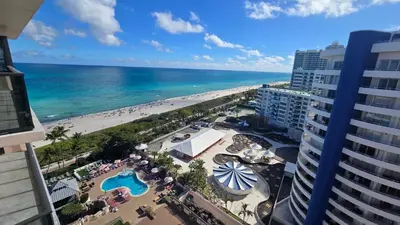a view of the beach from the balcony of a building at Penthouse Condo - Oceanfront - Miami Beach - sleeps 8 in Miami Beach