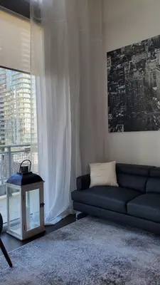 a living room with a blue couch and a table at Brickell Condo, with FREE parking in Miami