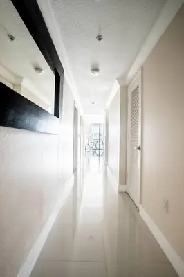 a hallway of a home with a large painting on the wall at Le Marina Bay 1006 STR-01435 in Sunny Isles Beach