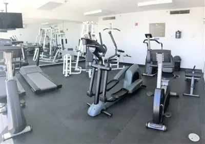 a gym with several treadmills and machines at Le Marina Bay 1006 STR-01435 in Sunny Isles Beach