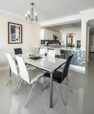 a kitchen and dining room with a table and chairs at Le Marina Bay 1006 STR-01435 in Sunny Isles Beach