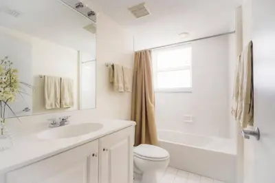 a white bathroom with a sink and a toilet at Le Marina Bay 1109 STR-01972 in Sunny Isles Beach
